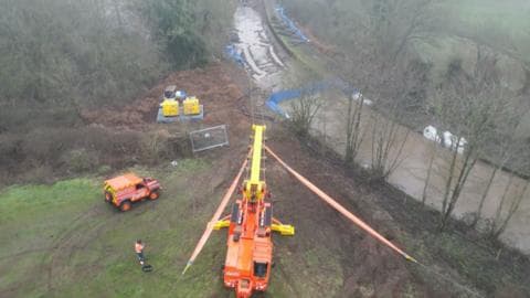 Stranded narrowboat pulled out of canal hole