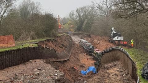 Stranded narrowboat pulled out of canal hole